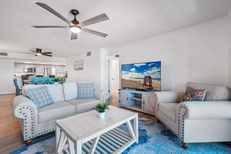 Relax on comfortable couches and watch your favorite shows on the large TV in the oceanfront living room with stunning beach views Relax on comfortable couches and watch your favorite shows on the large TV in the oceanfront living room with stunning beach views