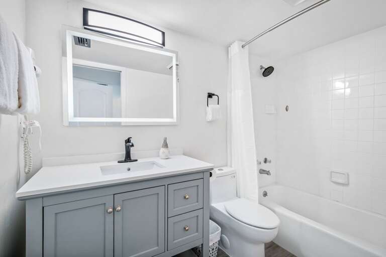 The south guest bedroom includes a private ensuite bathroom with a tub/shower combo and an anti-fog mirror The south guest bedroom includes a private ensuite bathroom with a tub/shower combo and an anti-fog mirror