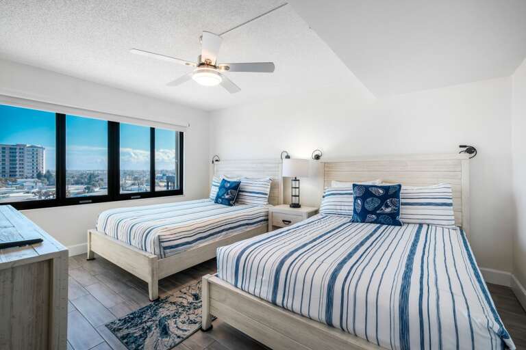 The south guest bedroom offers two queen beds and a large TV—plenty of space and comfort for guests The south guest bedroom offers two queen beds and a large TV—plenty of space and comfort for guests