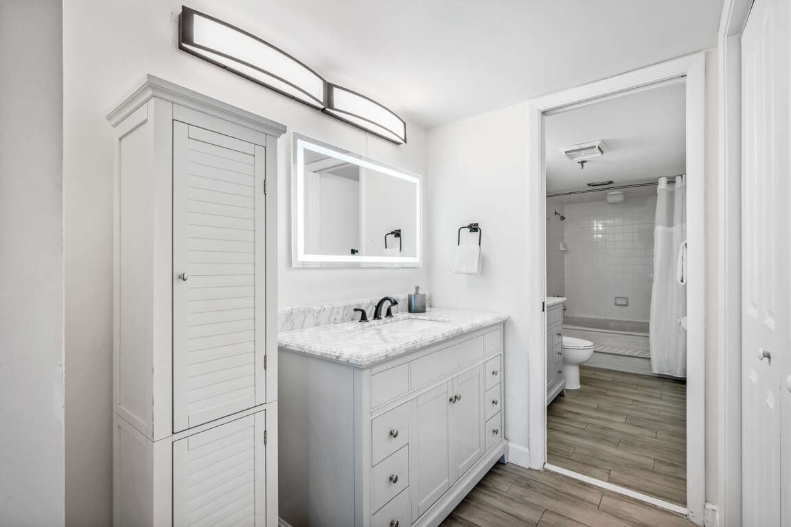 The updated master bathroom provides a spa experience with multiple vanities, a large bath tub, an anti-fog mirror, and plush, white towels The updated master bathroom provides a spa experience with multiple vanities, a large bath tub, an anti-fog mirror, and plush, white towels