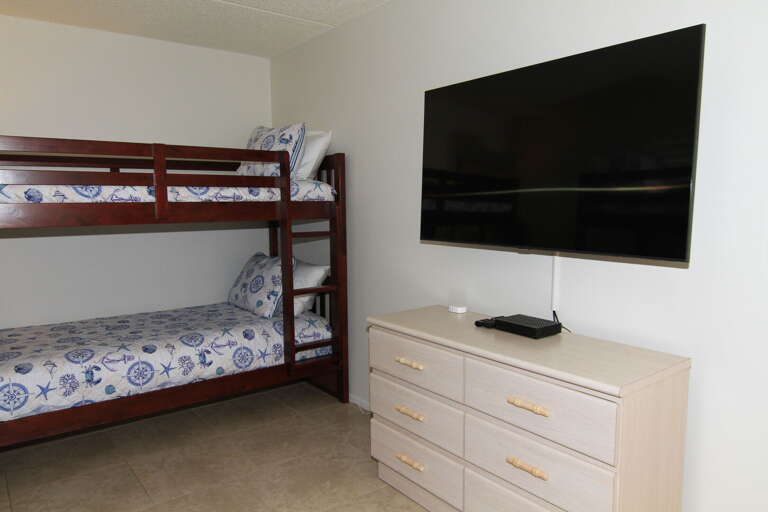 Enjoy entertainment in the guest bedroom with a large mounted TV, offering comfort and convenience during your stay Enjoy entertainment in the guest bedroom with a large mounted TV, offering comfort and convenience during your stay