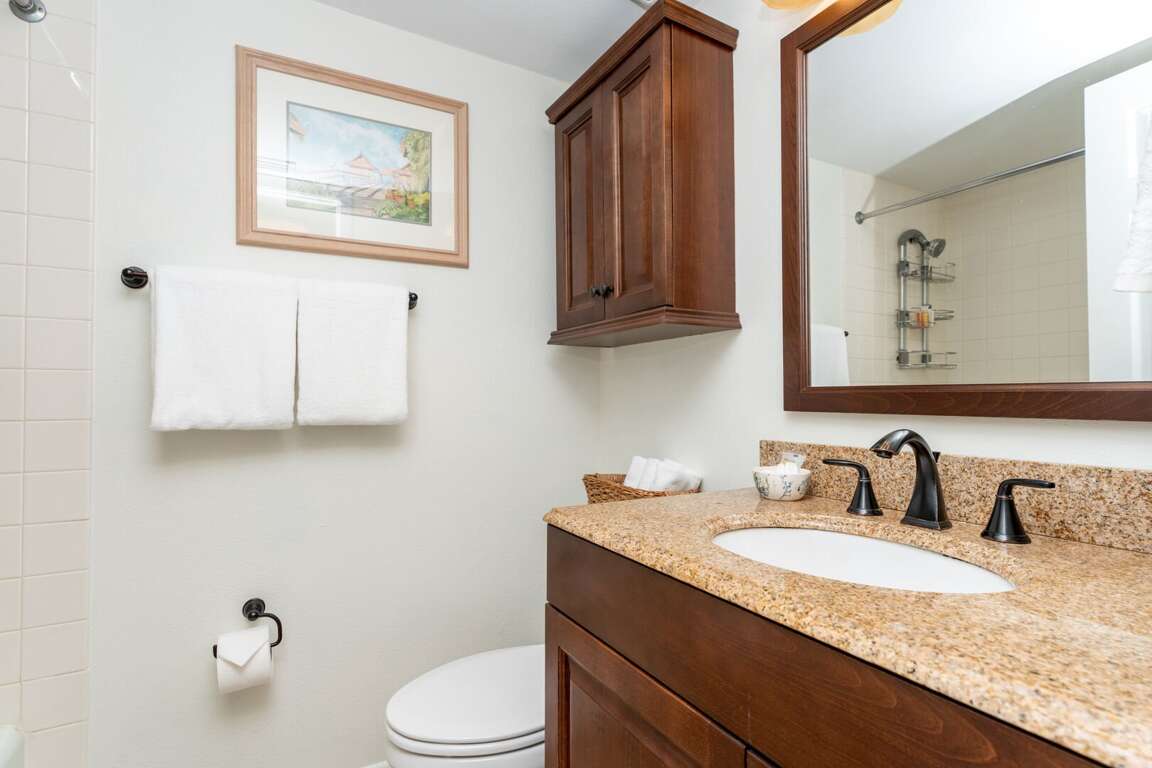 The ensuite master bathroom boasts granite countertops and plush spa towels The ensuite master bathroom boasts granite countertops and plush spa towels