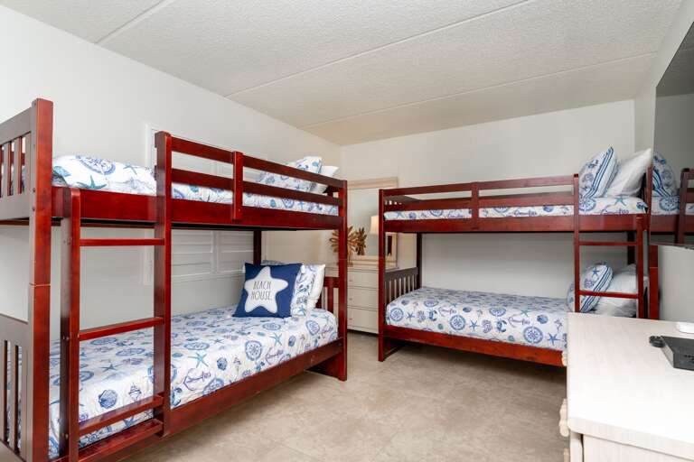 The guest bedroom comfortably sleeps 4, featuring two twin bunk beds and a TV, making it ideal for kids or friends The guest bedroom comfortably sleeps 4, featuring two twin bunk beds and a TV, making it ideal for kids or friends