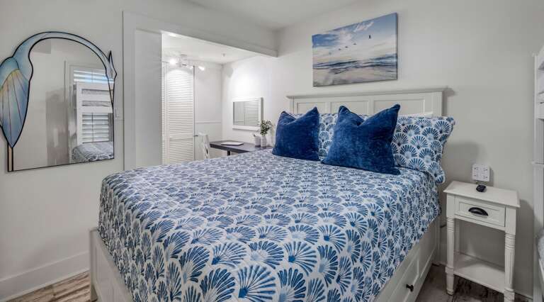 Next to the guest bedroom's queen bed, you'll find a dedicated workspace and spacious closet