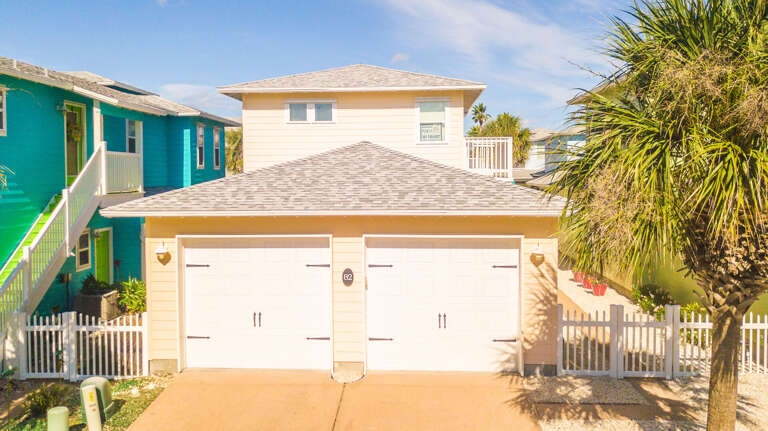 Beach House With Double Garage And Palm Tree