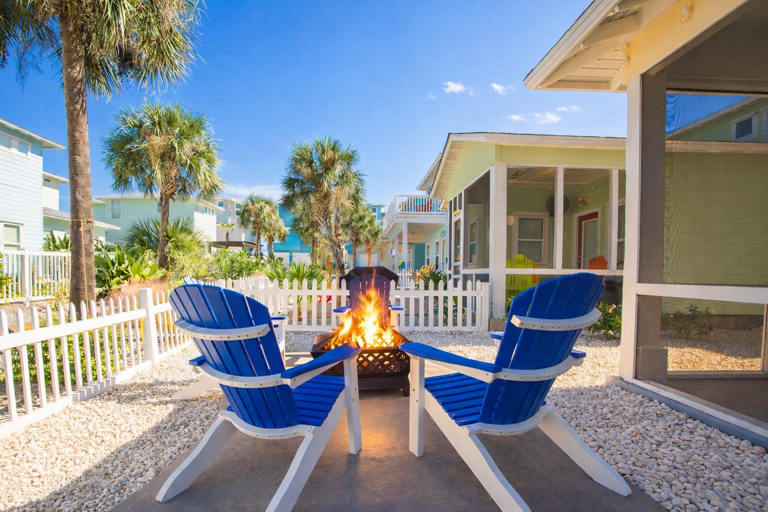 Blue Chairs, Fire Pit, Palm Trees, White Fence, Sunny Sky