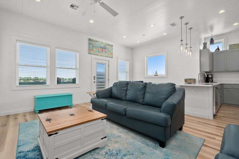 Interior Living Space With Sofa, Kitchenette, And Bright Windows
