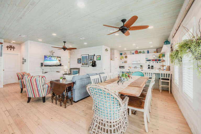Interior View Of A Dining Area With Mixed-style Chairs And Ceiling Fans