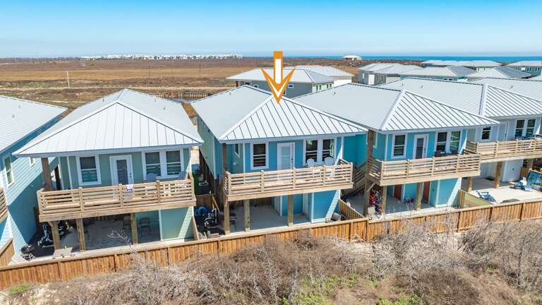 Row Of Blue-roofed Buildings By The Beach