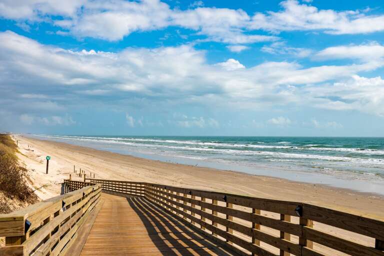 Boardwalk Leading To Breezy Beach, Blue Sky Above