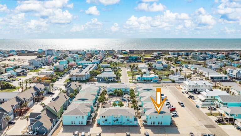 Aerial View Of A Bustling Beachside Vacation Rental Community