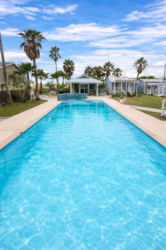 Palm-lined Pool Under Vibrant Sky