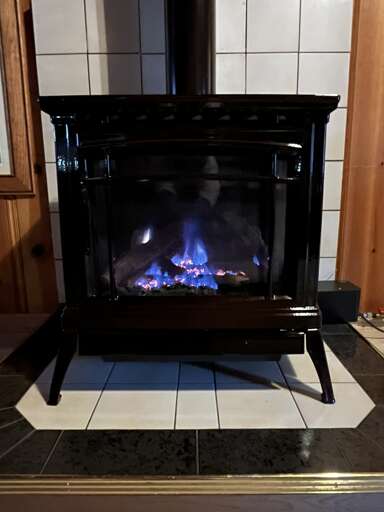Black Fireplace With Blue Burning Flames
