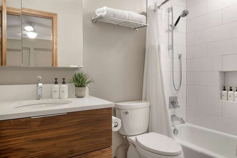 The second bedroom includes an ensuite bathroom with a tub-shower combination and a single vanity.