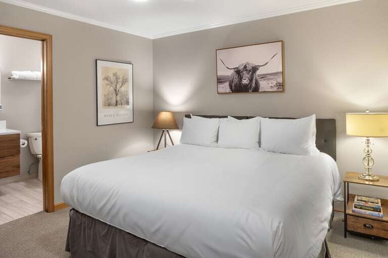 The second bedroom offers flexible bedding with two twin beds that can convert to a king upon request, plus a private en suite bathroom.