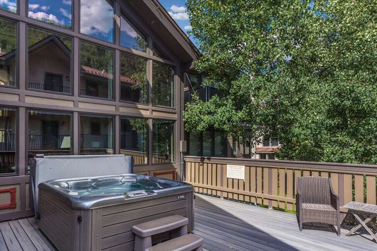 The communal hot tub is conveniently located just steps from your unit.