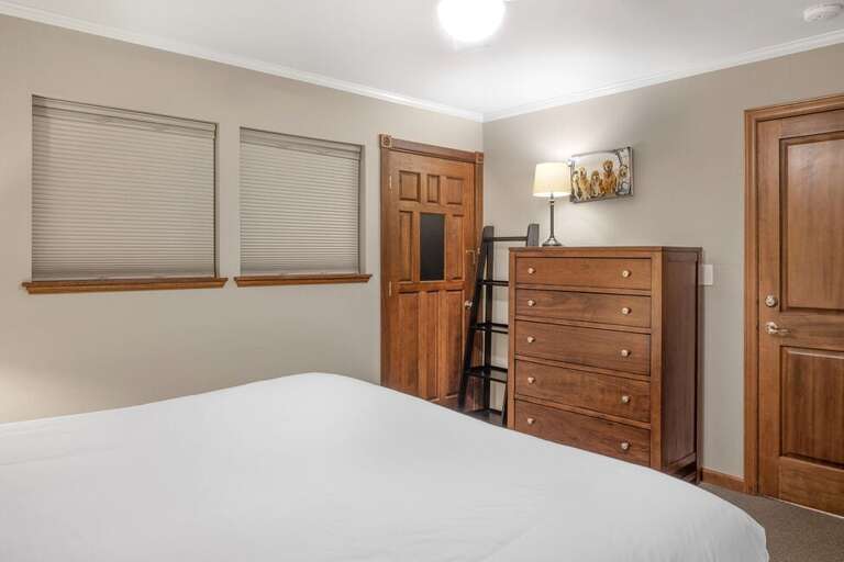 This room features large closet and dresser for storage as well as ensuite bathroom.