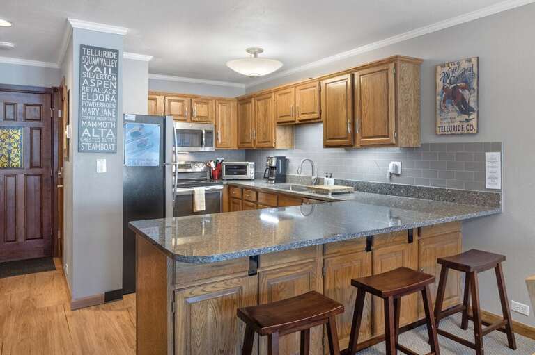 This Unit boasts a spacious, fully-stocked kitchen with full-size refrigerator, oven, microwave and dishwasher.