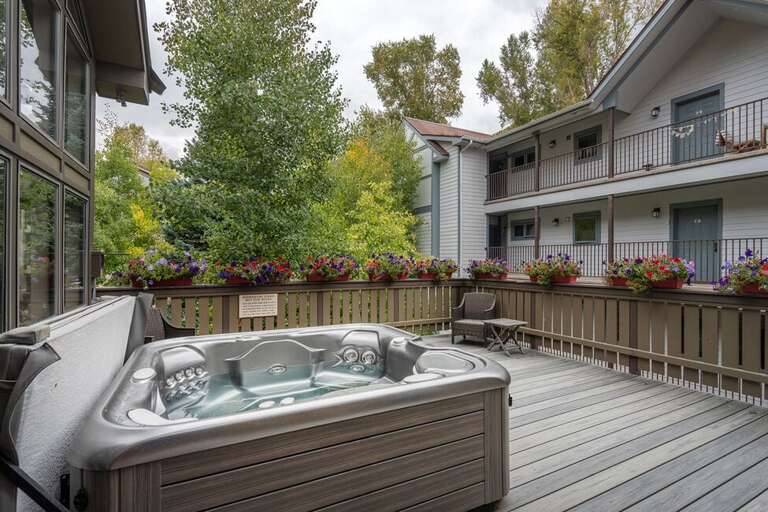 The communal hot tub is on a welcoming deck  one floor down from the unit.