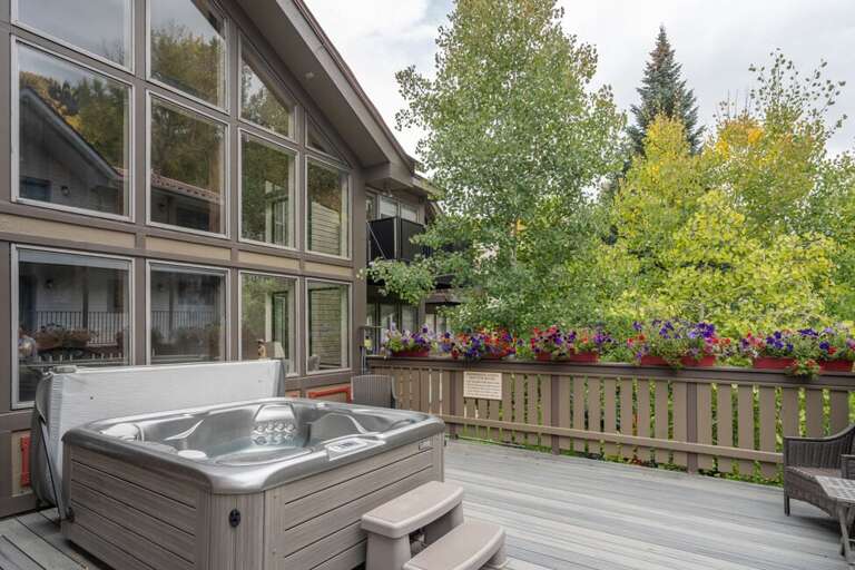 The communal hot tub is on a welcoming deck located one floor down from the unit.
