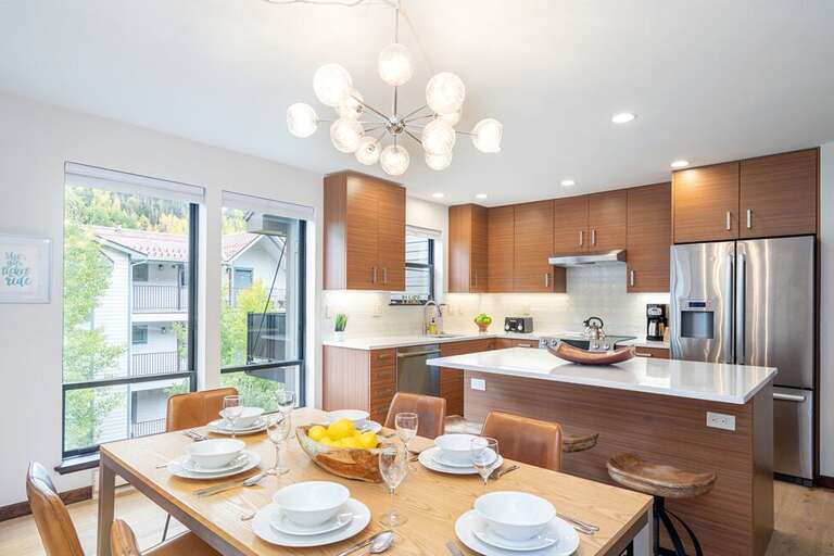 The dining area separates the kitchen/ living room- and provides seating for 6!