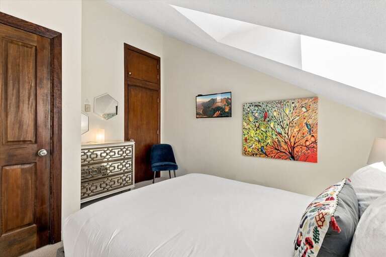 Guest room Two with queen bed with dresser and closet.