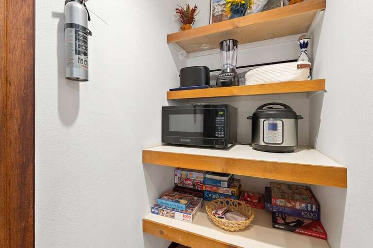 Pantry closet near kitchen is home to additional kitchen amenities.