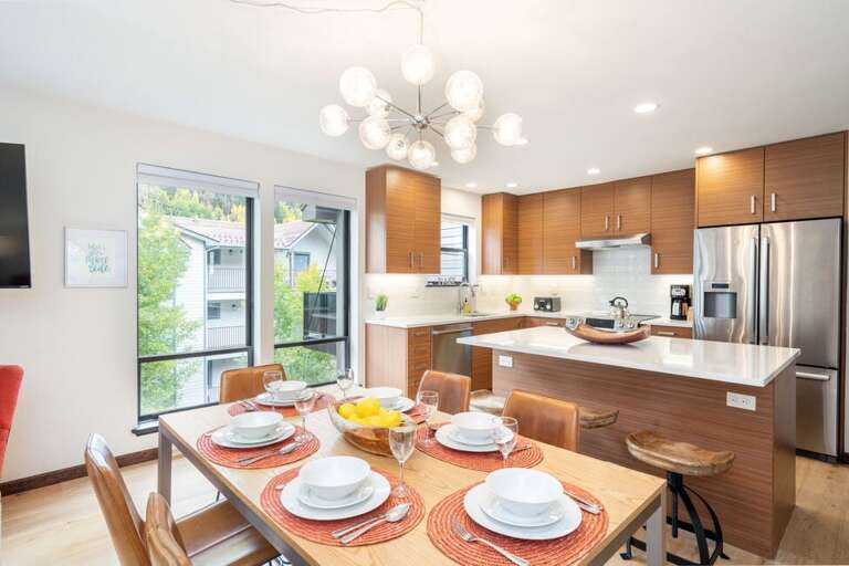 Spacious Modern Kitchen with stainless steel appliances, large island and dining table seating for 6.
