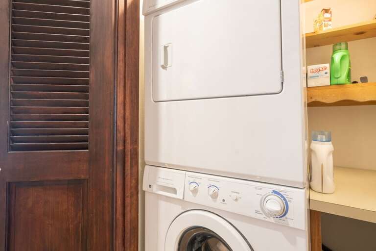 Stackable Washer + Dryer located on the main floor off of the kitchen.