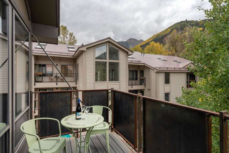 Sunny private deck off of the living room is ideal for watching the mountains.