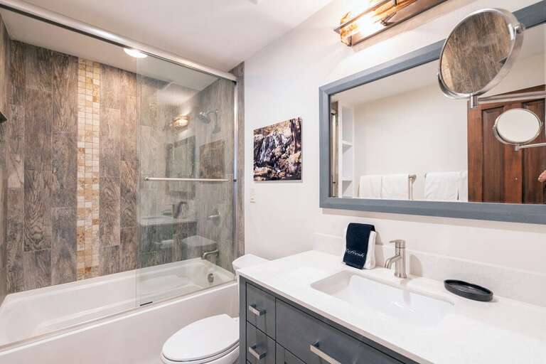 The upstairs shared bathroom features  tub/shower combo and single vanity.