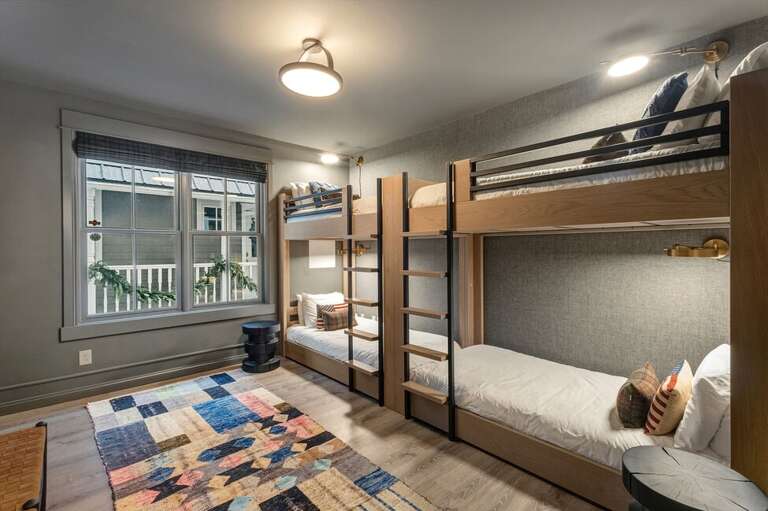 The bunk room features two stylish sets of twin bunk beds offering extra space for additional guests or a kid slumber party.