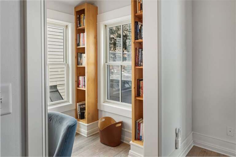 A cozy office nook just off of the living room  perfect place to enjoy a book or work on a puzzle.