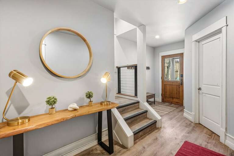 The first floor features three guest bedrooms, one with an en suite bathroom, and an additional shared bathroom in the hallway.