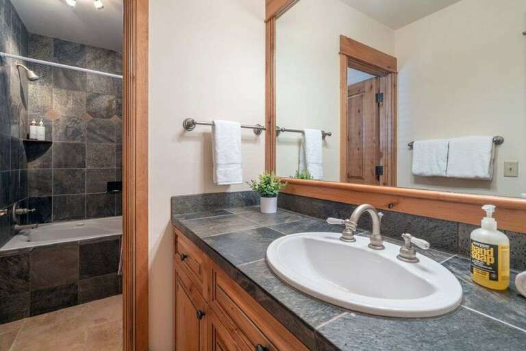 Full Guest bathroom, on the entry level, features soaking tub and shower combo. Full Guest bathroom, on the entry level, features soaking tub and shower combo.