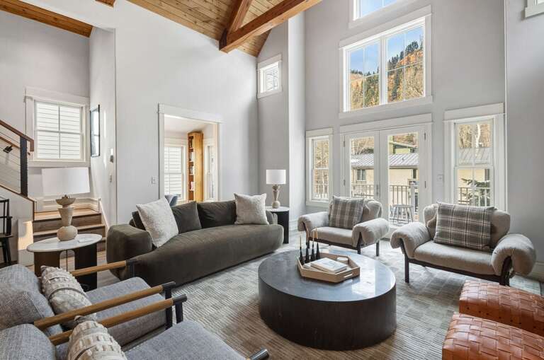 The great room provides high ceilings,  natural light a cozy gas fireplace as well as stunning views of the surrounding mountains.