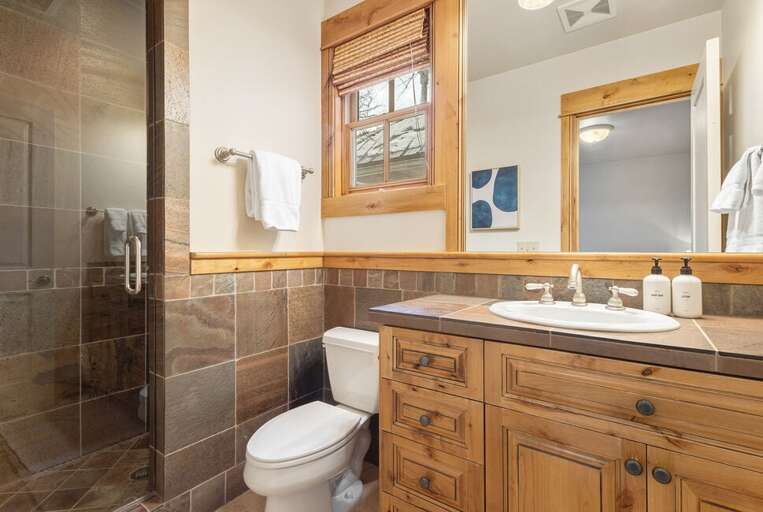 This guest bedroom ensuite features step in shower and single vanity.
