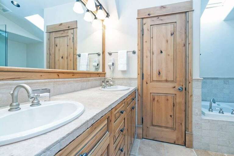 The primary suite bathroom features a double vanity, water closet, soaking tub and step in shower. The primary suite bathroom features a double vanity, water closet, soaking tub and step in shower.