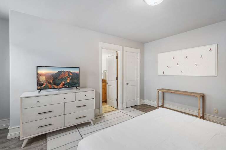 Spacious guest room with ensuite bathroom and king bed.