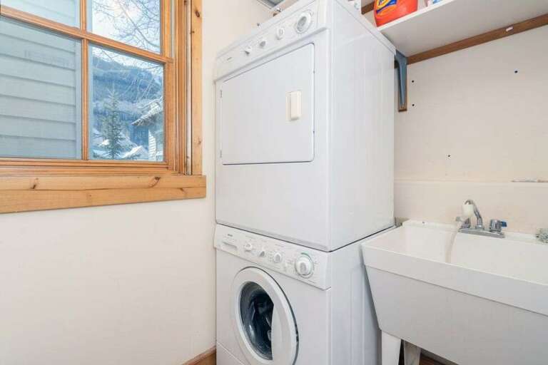 Stackable Washer and Dyer are located in a full laundry room just off of the kitchen. Stackable Washer and Dyer are located in a full laundry room just off of the kitchen.