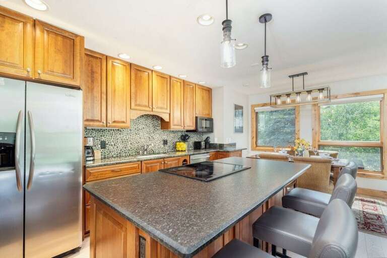 Spacious kitchen area with bar seating as well as dining for four. Spacious kitchen area with bar seating as well as dining for four.