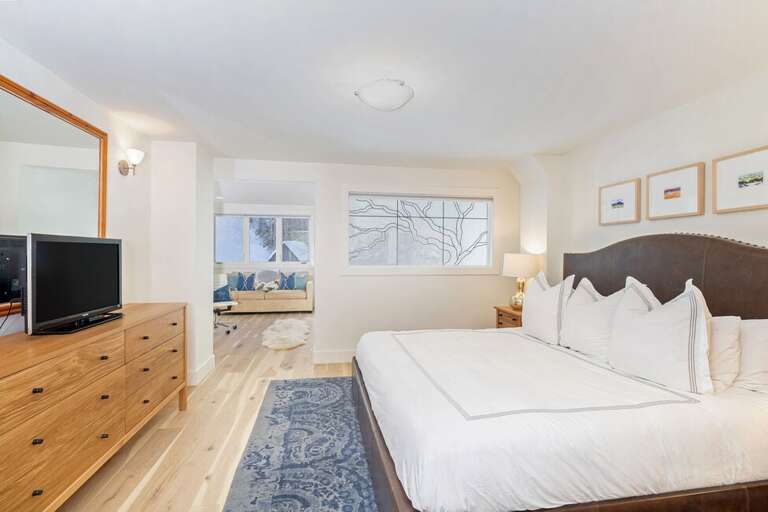 The upstairs king master has a TV, and nook area with sleeper sofa and desk.