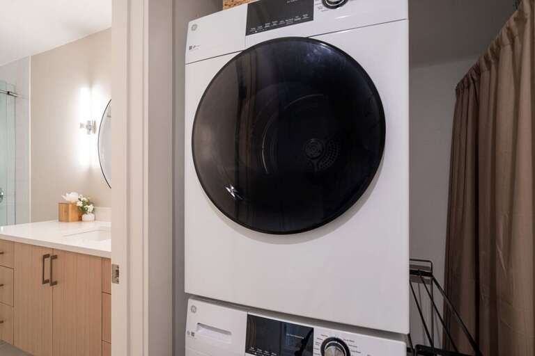There is a washer and dryer on the main living level, next to the bathroom.
