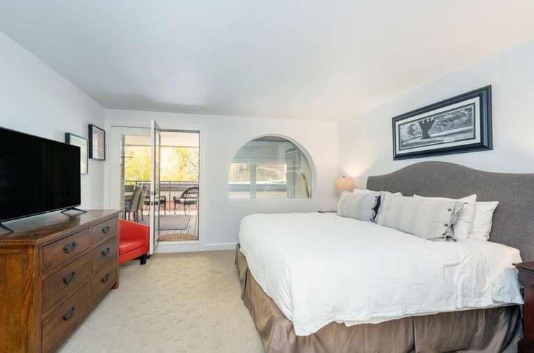 Enjoy a sunny deck with stellar views off the second floor Primary King  Bedroom.
