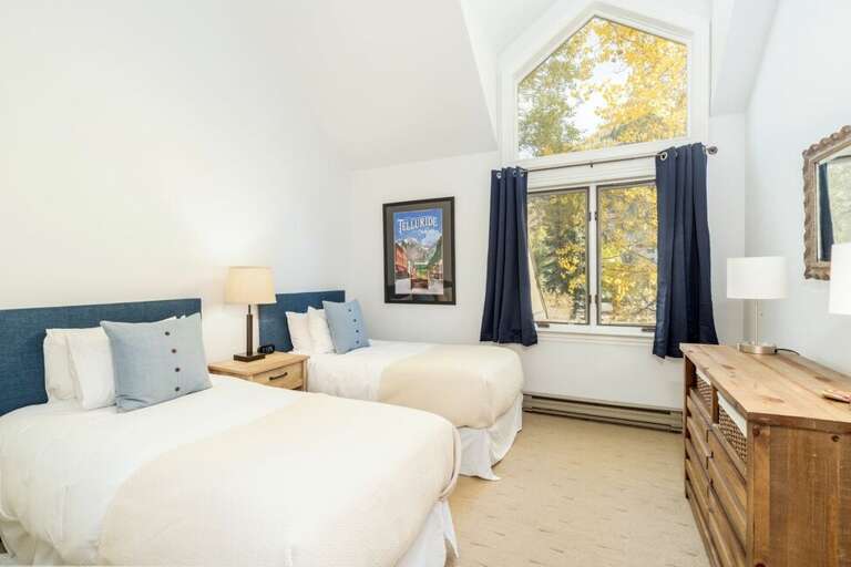 The first floor bedroom is complete with two twins that can be converted into a King-  San Miguel River is just outside the windows that bring lots of light.