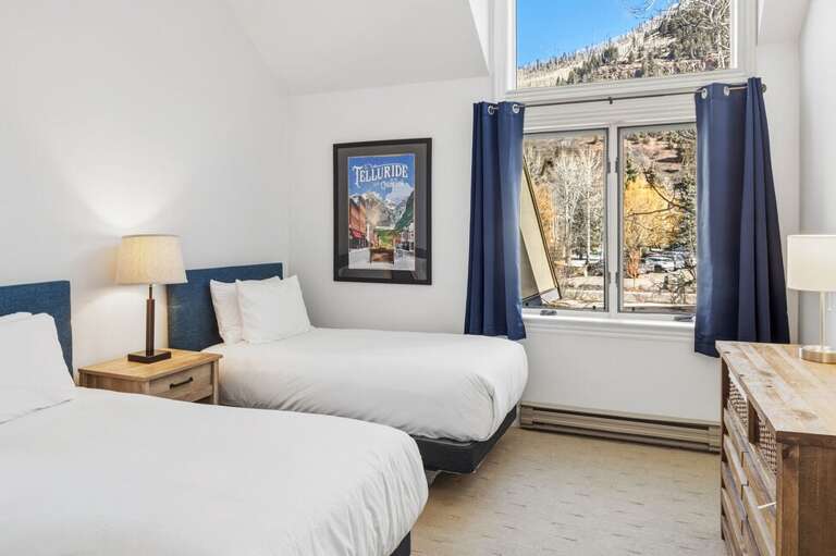 The guest room off the living area features twin beds (which can be combined into a king for added flexibility and comfort.)