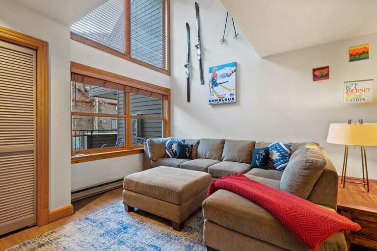Cozy living area with large L-shaped couch perfect for movie time, game night or enjoying the views.