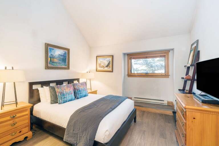 On the main Level of the condo is the guest bedroom which features a Queen size bed and ample storage.