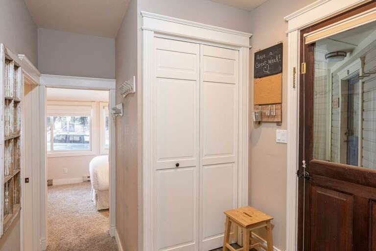 Enter into a mudroom area with a coat closet and wall hooks. Ski storage is just outside the front door.