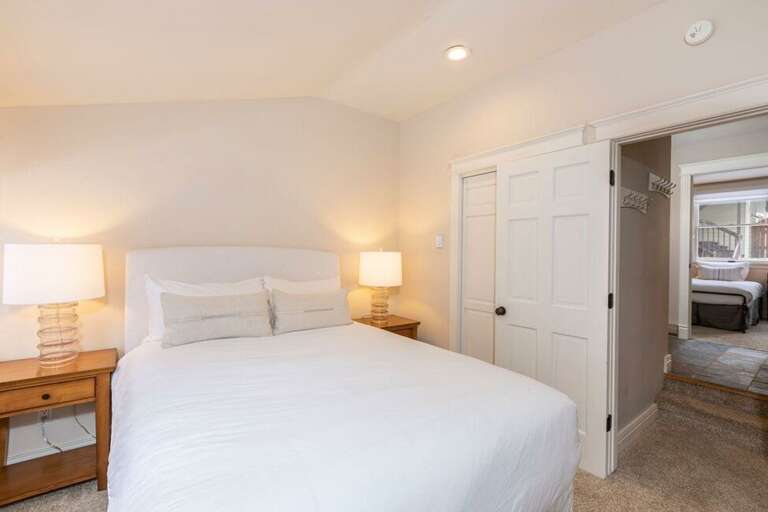 There is a full bathroom located just outside the queen bedroom. Across the hall is the twin bedroom.